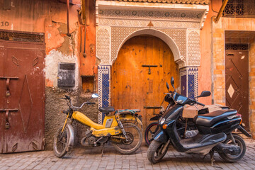 The scooters parked in the sidewalk of Medina area, Marrakech, Morocco, Africa