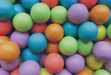 Background from multicolored bright small wooden balls of blue, yellow, red, lilac and green colors. 