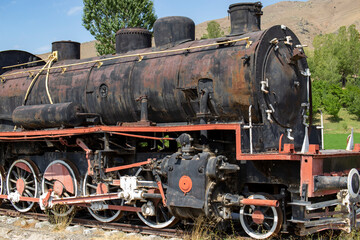 Fototapeta na wymiar Two hundred years old train in muradiye district of van province. Turkey. locomotive in black color.