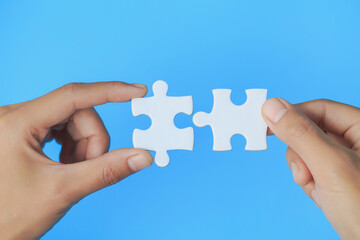 Businessman hand connecting jigsaw puzzle, Business solutions, target, success, goals and strategy...