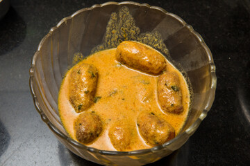 An Indian vegetarian food Malai Kofta being prepared by deep frying corn balls stuffed with meshed potatoes and paneer and topped up with rich creamy gravy or curry