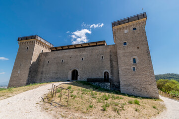 The Rocca Albornoziana overlooking the historic center of Spoleto, Italy, on a sunny day