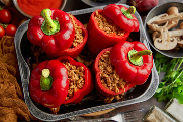 Sweet red peppers stuffed with meat and tomato in a vintage frying tray. Top view