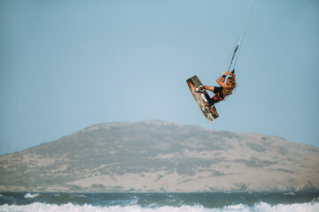 A kite surfer rides the waves