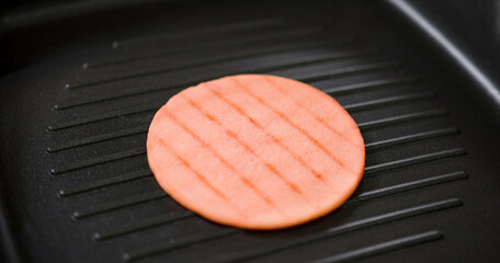 Grilled ham bologna in a hot black pan, Close up Front view food concept. © Artstore Studio