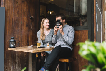 Positive couple taking photo in cafe