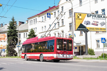 Fototapeta na wymiar IVANO-FRANKIVSK, UKRAINE - May 09, 2021. Trolleybus BKM 321 #232 riding with passengers in the streets of Ivano-Frankivsk.