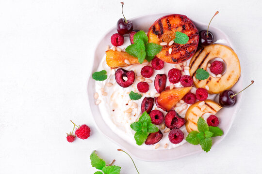 Grilled Peach And Apple In Cottage Cheese Cream Topped With Raspberry, Cherry, Mint And Pine Nuts. Served Summer Dessert