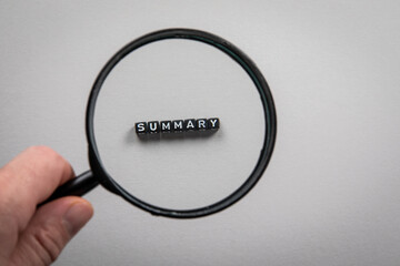 SUMMARY. Search, accounting, audit and survey concept. magnifying glass in a man's hand