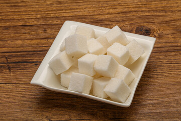 Refined white sugar cubs in the bowl