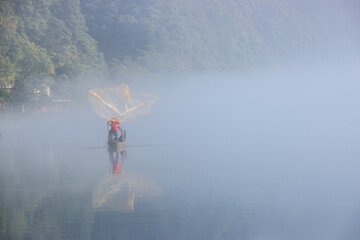 casting fishing net closeup on mist river