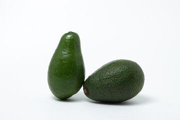 Two whole avocados on a white background. Isolated green avocado.