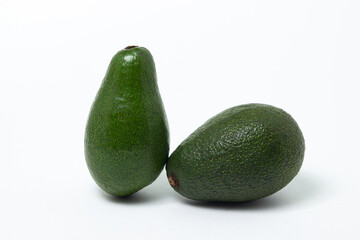 Two whole avocados on a white background. Isolated green avocado.