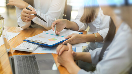Business team brainstorming, corporate business crew, with financial reports and laptop