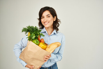 woman with paper bag of groceries supermarket lifestyle