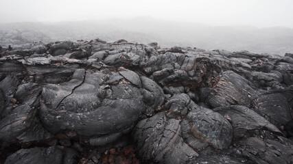 The steam coming out of the cracks of volcanic lava layer. Tolbachik volcano, Kamchatka, Russia.