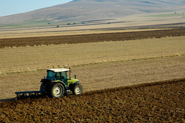 Obraz premium aerial photo of tractor plowing the field