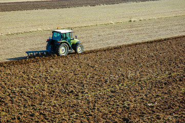 Obraz premium aerial photo of tractor plowing the field