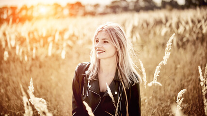 Sexy Young woman in a biker jacket Standing In Forest During Autumn