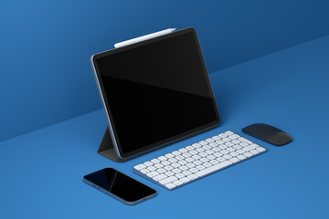 Computer tablet with keyboard, mouse and phone isolated on black background.