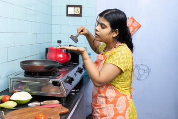 Indian housewife in kitchen