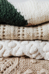 Folded winter sweaters close up
