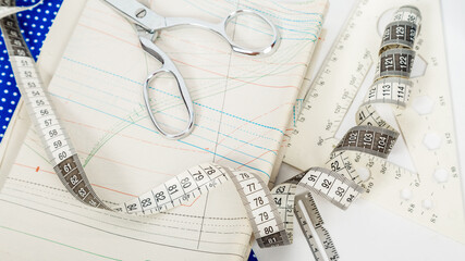 Tailoring. Fashion designer workspace top view. Sewing equipment,blue fabric, pattern.