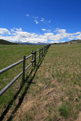 Fototapeta na wymiar Round rail fence under blue sky in the Bighorn Mountain range in the Rocky Mountains near Buffalo Wyoming USA