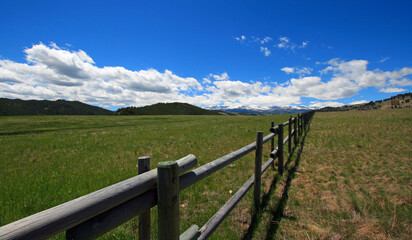 Fototapeta na wymiar Round rail fence under blue sky in the Bighorn Mountain range in the Rocky Mountains near Sheridan Wyoming USA