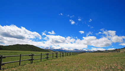 Fototapeta na wymiar Round rail fence under blue sky in the Bighorn Mountain range of Rocky Mountains in Wyoming USA