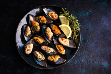 Steamed mussels with herbs and lemon. Tapas plate with mussels. Food photography