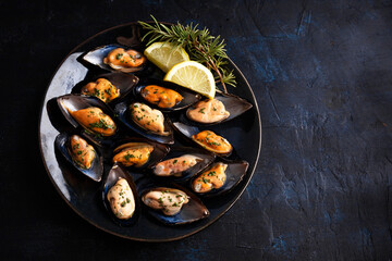 Steamed mussels with herbs and lemon. Tapas plate with mussels. Food photography