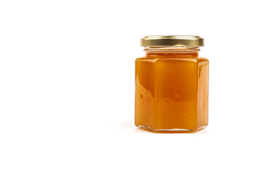 Glass jar full of sweet honey isolated on white background