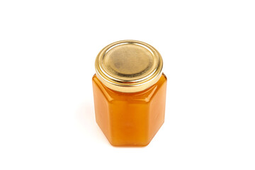 Glass jar full of sweet honey isolated on white background