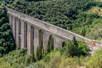 Fototapeta na wymiar Beautiful top view of the ancient Ponte delle Torri bridge, Spoleto, Italy, on a sunny day