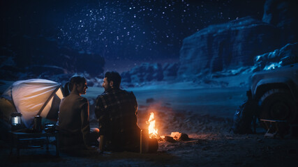 Happy Couple Nature Camping in the Canyon, Sitting Watching Campfire Together, Talking, Watching...