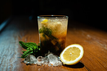 Refreshing rum and cola drink with mint and brown sugar