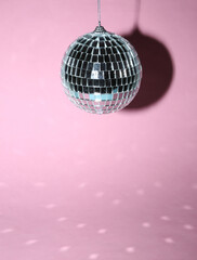 Disco ball on a pink bright background. Minimalism party concept