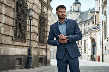 Handsome male model in checked suit walking on the street