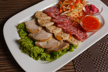 meat and bacon on a plate