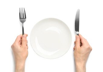 Top view of woman with cutlery and empty plate on white background, closeup