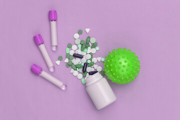 Pills bottle with Medical test tubes, virus strain model on purple background. Treatment. Top view