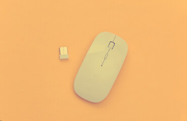 White modern wireless pc mouse on yellow background. Top view