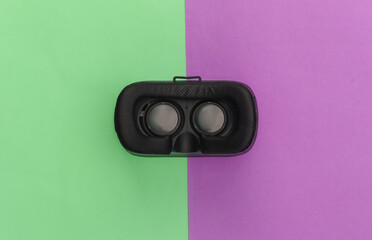 Virtual reality headset on pink green pastel background. Top view. Flay lay. Minimalism