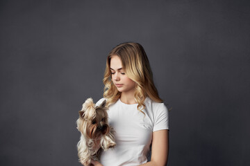 blonde with a small purebred dog joy smile dark background