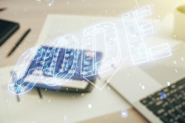 Code word hologram on blurry calculator with laptop background, artificial intelligence and neural networks concept. Multiexposure