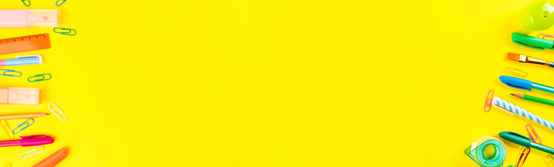 Back to school concept. Colorful writing tools web banner on yellow background