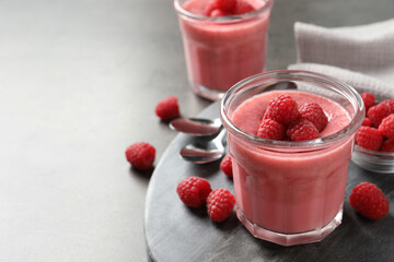 Delicious raspberry mousse served on grey table, space for text