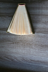 Vintage hardcover book on a wooden table. Top view.