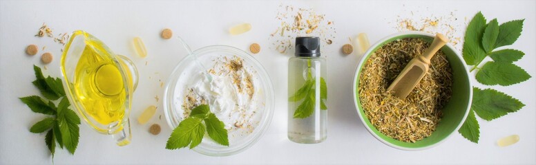 Banner with alternative medicine, herbal extracts white background, jar of oil over a bowl with...